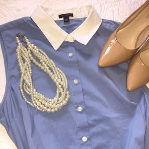 Striking blue and white collared sleeveless blouse